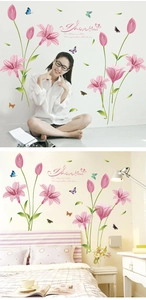 Detailed view of pink tulip and butterfly wall stickers applied in a cozy bedroom setting