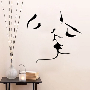 Minimalist black vinyl wall sticker featuring kissing couple facial line art on white wall