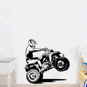 Detail of a black motocross silhouette wall decal in a minimalist bedroom setting