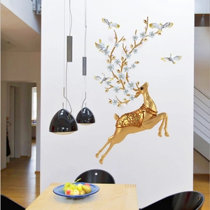 Golden jumping deer wall decal with floral antlers and white doves in a modern dining room