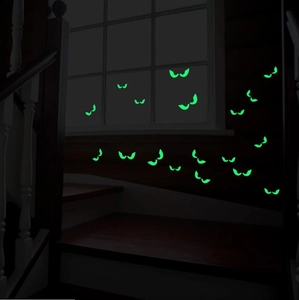 Glow-in-the-dark Halloween wall stickers featuring glowing green peeping eyes on stairs
