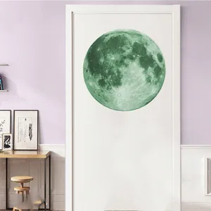 Luminous moon wall sticker with green texture details on a white wooden door decor