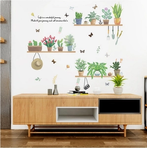 Detail of green potted plants wall stickers with motivational quotes on white wall