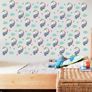 Detail view of rainbow unicorn wall stickers with colorful heart and cloud patterns in nursery
