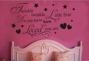 Detail of Twinkle Little Star nursery wall decal with black stars and hearts on pink wall