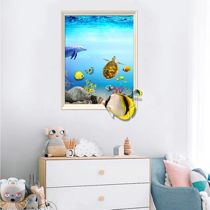3D ocean world wall decal with dolphins and tropical fish in a cozy kids room setting