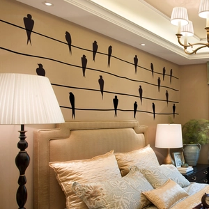 Minimalist black bird silhouette wall sticker above bed for modern bedroom decor