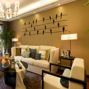 Detailed view of black bird silhouettes on power lines wall decal in a modern living room