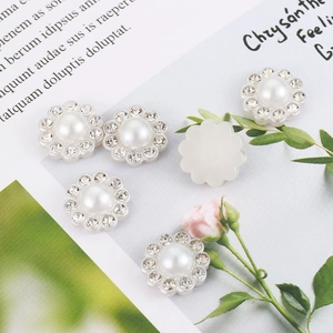Elegant pearl and rhinestone sunflower buttons for DIY sewing on floral background