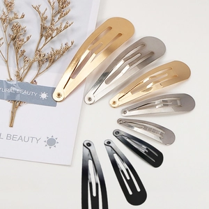 Polished metal snap hair clips in various sizes and colors including gold, silver, and black