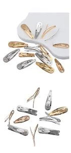 Detail showing classic silver and gold metal teardrop snap hair clips on a display board