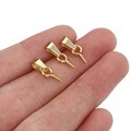 Three gold-plated stainless steel pinch bails for DIY jewelry making held in palm