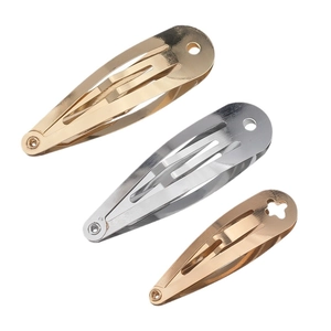 Three teardrop metal snap hair clips in gold and silver finish on white background