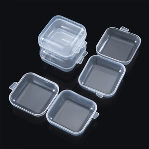 Set of transparent PP plastic storage boxes with flip lids and snap closures on black mirror