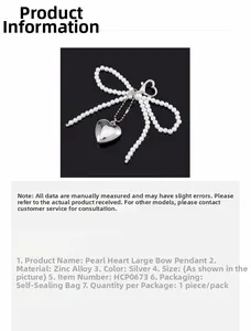 Detail of silver heart charm with white faux pearl bow pendant made of zinc alloy