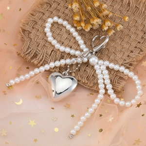 Elegant pearl bow heart keychain with silver metal pendant and heart-shaped carabiner