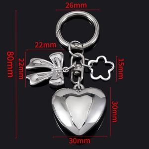 Silver metal keychain with 3D heart, butterfly, and flower charms on black background