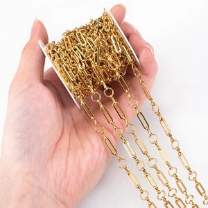 Golden stainless steel paperclip chain with round links on a spool for DIY jewelry making