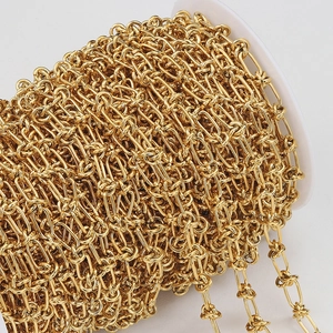 Close-up of polished gold-colored knotted chain on a roll for DIY jewelry making