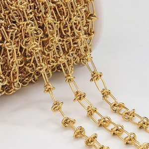 Detailed macro view of gold-plated knot chain on a roll for DIY jewelry making