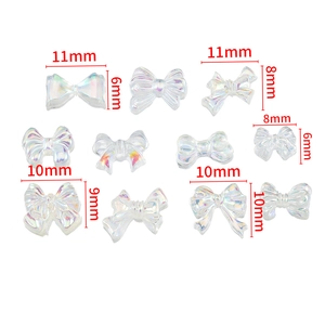 Aurora iridescent resin bow nail art charms in various sizes for DIY manicure