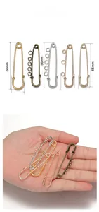 Macro view of decorative safety pins with multi-loops in various sizes and finishes