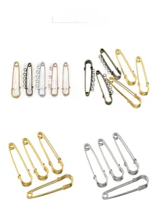 Detail view of metal safety pins in five colors with loops for jewelry making