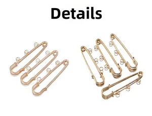Close-up of golden metal safety pins with triple loop design for DIY jewelry making