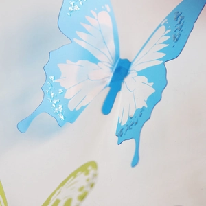 Detail showing 3D blue butterfly wall sticker with silver glitter and feather texture