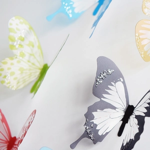 Detail of 3D decorative butterflies with glitter wings on a clean white background