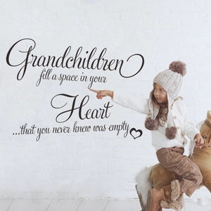 Grandchildren quote wall decal with heart design on white brick wall in living room