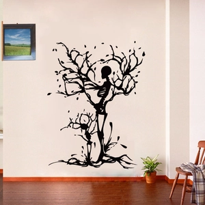 Artistic black skeleton tree PVC wall sticker shown in a minimalist living room interior
