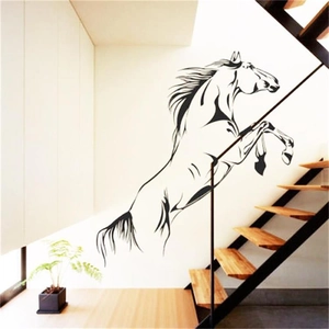 Detail of jumping horse wall sticker on modern white wall next to wooden stairs