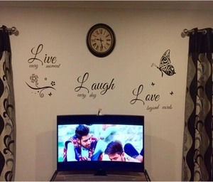 Detail of Live Love Laugh wall decals with black butterflies for living room decor