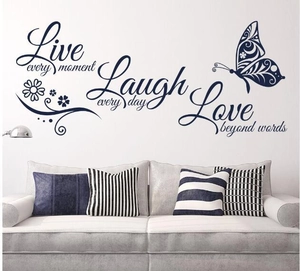 Detail of Live Love Laugh vinyl wall decal with butterflies in a modern living room