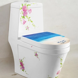 Detail showing cartoon floral and beach scenery stickers on a white ceramic toilet lid