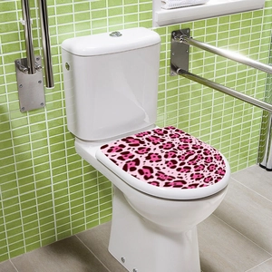 Detailed view of pink leopard print decorative sticker on a white toilet lid in bathroom