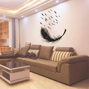 Modern wall sticker featuring black feather transforming into flying birds in living room