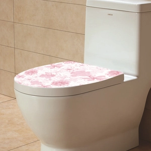 Detailed close-up of pink floral waterproof PVC decorative stickers on a toilet lid