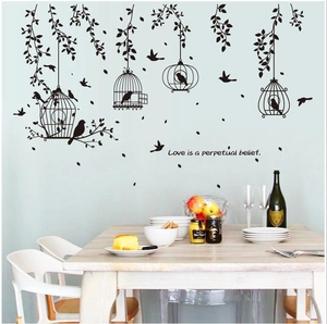 Black birdcage and leaf silhouette wall decals with Love is a perpetual belief quote