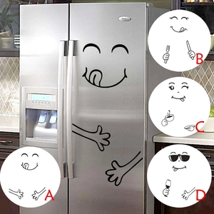 Close-up of four different funny cartoon smiley face vinyl fridge stickers in black