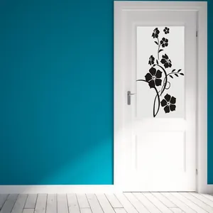 Detail view of black floral vine wall sticker applied on a white minimalist door
