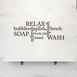 Detail view of black PVC bathroom wall decal with Relax and Wash lettering on grey wall