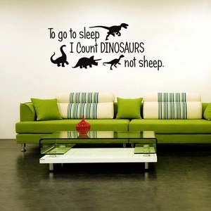 Detail of dinosaur themed wall decal featuring 'I count dinosaurs' quote in black font