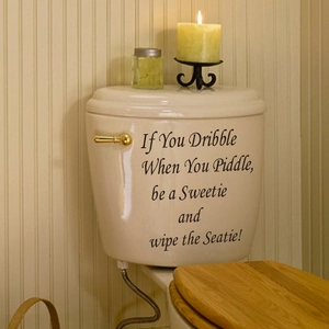 Funny If You Dribble bathroom wall decal on a white toilet with cozy home decor