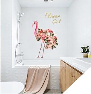 Floral flamingo wall decal with Flower Girl text applied on white bathroom tiles