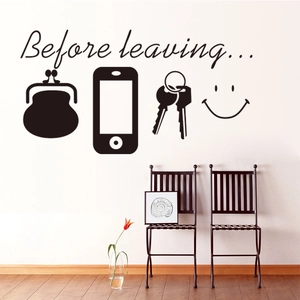 Modern black wall decal with Before leaving text and icons on white living room wall