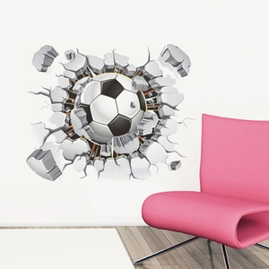 3D football breaking through wall sticker with realistic debris on a white background