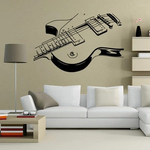 Artistic guitar wall decal silhouette displayed above a white sofa in a living room