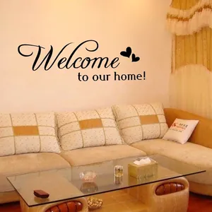 Black 'Welcome to our home' wall decal with heart accents for living room decor